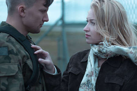 Young beauty woman and soldier saying goodbyeの写真素材