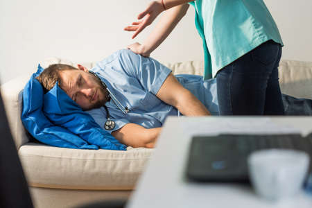 Horizontal view of doctor waking sleeping medicの写真素材