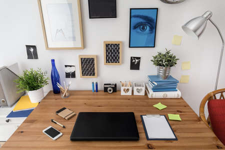 Laptop on the desk in designed modern workspaceの写真素材