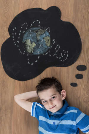 Boy dreaming about travel around the worldの写真素材