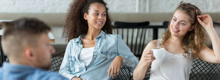 Group of young friends in the restaurantの写真素材