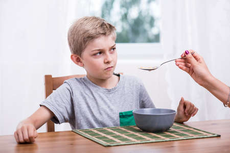 Poor eater refusing to eat milk with cerealの写真素材
