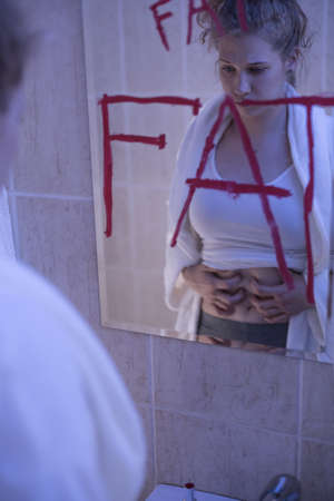 Image of beautiful young sick female hating her body