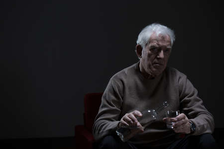 Portrait of senior man addicted to alcoholの写真素材