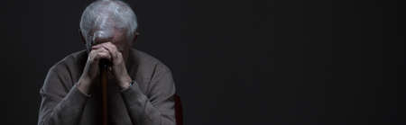 Despair elder man holding walking stick - panoramaの写真素材