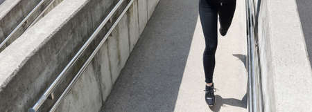 Banner of an athletic female legs during runの写真素材