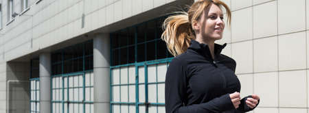 Panorama of a beautiful woman exercising outdoorsの写真素材