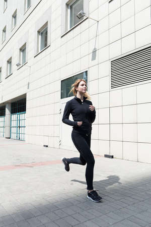 Picture of an attractive female jogging in the townの写真素材