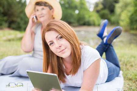 Image of modern girl spending leisure time with grandmaの写真素材