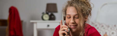 Smiling woman talking on the phone - panoramaの写真素材