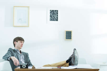 Young male designer taking break at workの写真素材