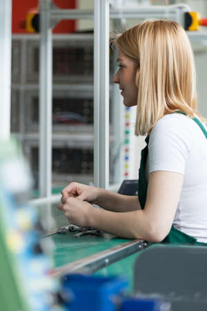 Young attractive woman is busy mounting small piecesの写真素材