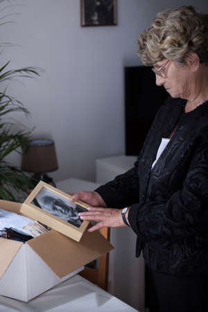 Elder lady being in mourning after dead husband