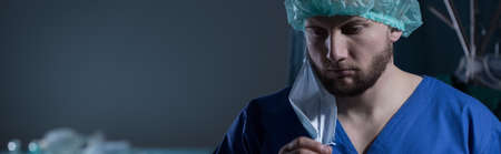 Young doctor is fatigued after having an operationの写真素材