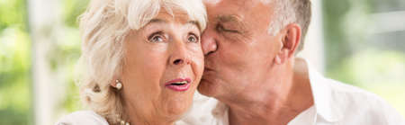 Elder man is kissing his wife