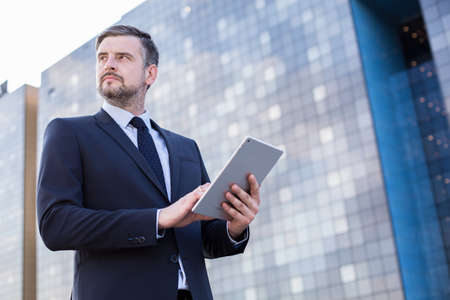 Image of handsome economic trade worker standing outdoorの写真素材