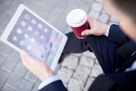 Close up of modern corporate worker using tablet for businessの写真素材