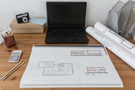 Photo of laptop and project on paper lying on tableの写真素材