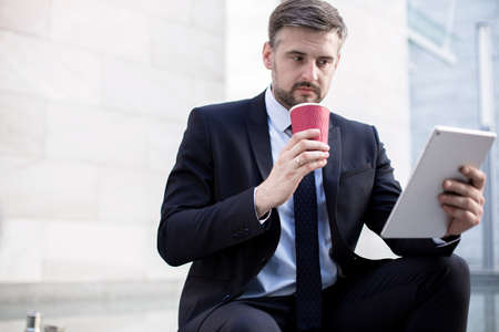 Photo of handsome creative company worker preparing presentation