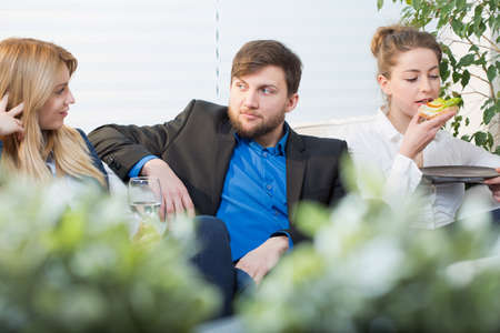 Coworkers having a break form work siting on the couch