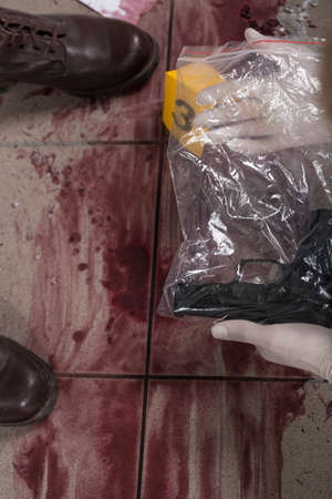 Blood and gun at the murder sceneの写真素材