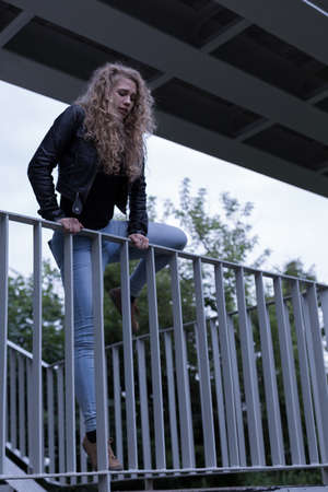 Picture of suicide female standing on the edge of bridgeの写真素材