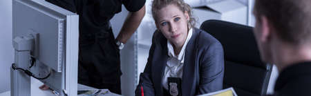 Horizontal view of female inspector and policemen