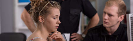 Young woman giving evidence on police stationの写真素材