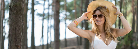 Portrait of a smiling young girl in summer hatの写真素材