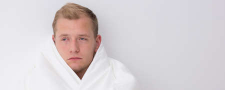 Young man feels very bad after long partyの写真素材