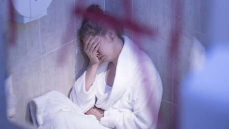 Young woman mirror reflection showing her mental breakdownの写真素材