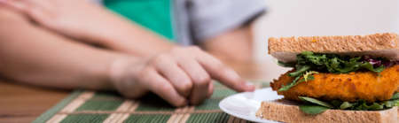 Little boy does not like a sandwich