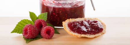 Sandwich with jar of delicous raspberry jam isolated