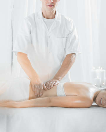 Picture of male masseur doing professional therapeutic massageの写真素材