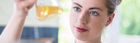 Female scientist analyzing result of chemistry experiment