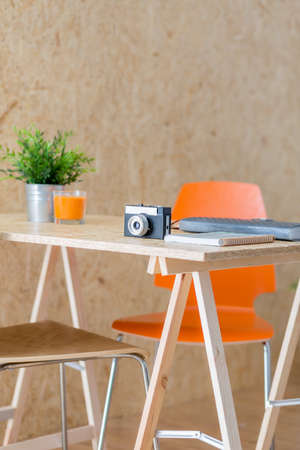 Image of camera lying on modern wooden table in studioの写真素材