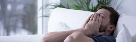 Panoramic view of exhausted young man after sleepless night
