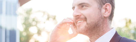 Handsome businessman being on the phone - panoramaの写真素材