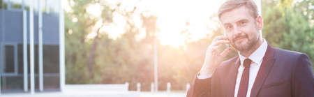 Adult businessman calling to employee after workの写真素材