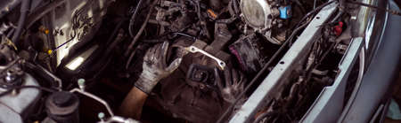 Close-up of auto mechanic fixing the engine