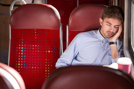 Picture of sleeping male passenger using public transportの写真素材