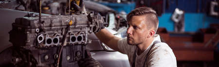 Young man working in auto repair workshop