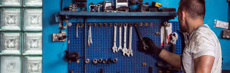 Wrenches and various equipment on the wallの写真素材
