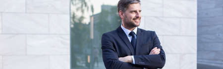 Attractive mature man in suit posing outdoorsの写真素材