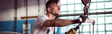 Horizontal view of repairer in the workshopの写真素材