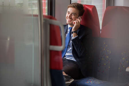 Photo of corporate worker with cellphone on business tripの写真素材