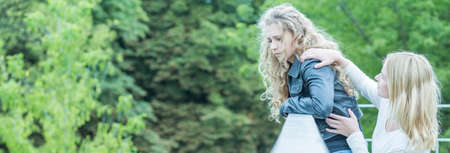 Young woman wants to jump from the bridgeの写真素材