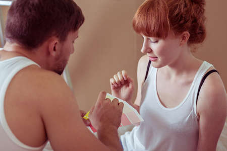 Young couple redecorating house and choosing colorsの写真素材