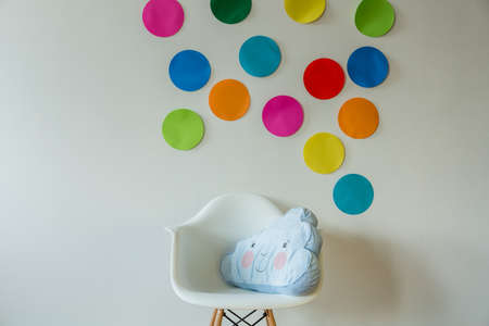 Cloud shaped pillow in cozy child's roomの写真素材