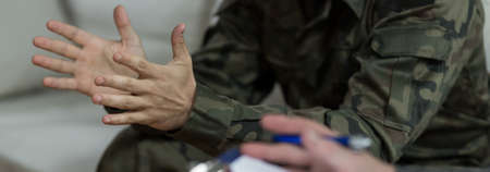 Soldier in green military uniform - closeup of handsの写真素材